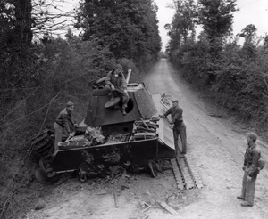 U.S. Army Air Forces pilots of the 366th Fighter Group look over a destroyed German Panzer V Panther tank in Normandy, France, 19 July 1944. The 366th FG was based at Saint-Pierre-du-Mont airfield, Calvados, France, from 17 June - 24 August 1944. Oroginal Caption: "P-47 pilots look over the result of their accurate and deadly fire to a knocked out German Panther tank, somewhere in France. Photo shows L to R; 1st Lt. Henry W. Collins, Atlanta, Ga.; 1st Lt. Bayard B. Taylor, Lincoln, Nebr.; and 1st Lt. Joe F. Richmond, of west Union, Ohio."