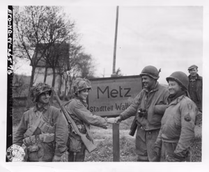Four infantrymen, members of two patrols that closed the escape gap east of Metz cutting off the escape of the encircled Germans in the town, shake hands after their mission has been accomplished. Left to right: S/Sgt Henry Tackett, Portsmouth, Ohio, S/Sgt Leonard Malicole, Cleveland, Ohio, and Tec 5 Ancil T. Horbison, Rockville, Ind. 5th Infantry Division & 95th Infantry Division. 19 November, 1944.