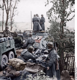 This is a retouched picture , which means that it has been digitally altered from its original version. Modifications: recolored . The original can be viewed here: Bundesarchiv Bild 101III-Wiegand-117-01, Russland, motorisierte Einheit der SS-Totenkopf-Division.jpg : . Modifications made by Ruffneck'88 . .mw-parser-output table.commons-file-information-table,.mw-parser-output .fileinfotpl-type-information,.mw-parser-output .fileinfotpl-type-artwork{border:1px solid var(--border-color-base,#a2a9b1);background-color:var(--background-color-interactive-subtle,#f8f9fa);padding:5px;font-size:95%;border-spacing:2px;box-sizing:border-box;margin:0;width:100%;color:inherit}.mw-parser-output table.commons-file-information-table>tbody>tr,.mw-parser-output .fileinfotpl-type-information>tbody>tr,.mw-parser-output .fileinfotpl-type-artwork>tbody>tr{vertical-align:top}.mw-parser-output table.commons-file-information-table>tbody>tr>td,.mw-parser-output table.commons-file-information-table>tbody>tr>th,.mw-parser-output .fileinfotpl-type-information>tbody>tr>td,.mw-parser-output .fileinfotpl-type-information>tbody>tr>th,.mw-parser-output .fileinfotpl-type-artwork>tbody>tr>td,.mw-parser-output .fileinfotpl-type-artwork>tbody>tr>th{padding:4px}.mw-parser-output .fileinfo-paramfield{background:#ccf;text-align:right;padding-right:0.4em;width:15%;font-weight:bold;color:inherit}.mw-parser-output .commons-file-information-table+table.commons-file-information-table,.mw-parser-output .commons-file-information-table+div.commons-file-information-table>table{border-top:0;padding-top:0;margin-top:-8px}@media only screen and (max-width:719px){.mw-parser-output table.commons-file-information-table,.mw-parser-output .commons-file-information-table .fileinfotpl-type-information,.mw-parser-output .commons-file-information-table .fileinfotpl-type-artwork{border-spacing:0;padding:0;word-break:break-word;width:100%!important}.mw-parser-output .commons-file-information-table>tbody,.mw-parser-output .fileinfotpl-type-information>tbody,.mw-parser-output .fileinfotpl-type-artwork>tbody{display:block}.mw-parser-output .commons-file-information-table>tbody>tr>td,.mw-parser-output .commons-file-information-table>tbody>tr>th,.mw-parser-output .fileinfotpl-type-information>tbody>tr>td,.mw-parser-output .fileinfotpl-type-information>tbody>tr>th,.mw-parser-output .fileinfotpl-type-artwork>tbody>tr>td,.mw-parser-output .fileinfotpl-type-artwork>tbody>tr>th{padding:0.2em 0.4em;text-align:left;text-align:start}.mw-parser-output .commons-file-information-table>tbody>tr,.mw-parser-output .fileinfotpl-type-information>tbody>tr,.mw-parser-output .fileinfotpl-type-artwork>tbody>tr{display:flex;flex-direction:column}.mw-parser-output .commons-file-information-table+table.commons-file-information-table,.mw-parser-output .commons-file-information-table+div.commons-file-information-table>table{margin-top:-1px}.mw-parser-output table .fileinfo-paramfield{box-sizing:border-box;flex:1 0 100%;width:100%}}.mw-parser-output table.commons-file-information-table,.mw-parser-output .fileinfotpl-type-information,.mw-parser-output .fileinfotpl-type-artwork,.mw-parser-output .fileinfo-paramfield{color:var(--color-base,#202122)}html.skin-theme-clientpref-night .mw-parser-output .fileinfo-paramfield{background:#2a2a5c;color:white}html.skin-theme-clientpref-night .mw-parser-output .fileinfotpl-type-artwork tbody>tr>th[style*="#ccf"]{background-color:#2a2a5c!important;color:white}@media screen and (prefers-color-scheme:dark){html.skin-theme-clientpref-os .mw-parser-output .fileinfo-paramfield{background:#2a2a5c;color:white}html.skin-theme-clientpref-os .mw-parser-output .fileinfotpl-type-artwork tbody>tr>th[style*="#ccf"]{background-color:#2a2a5c!important;color:white}} Russland, motorisierte Einheit der SS-Totenkopf-Division ( ) Photographer Wiegand Archive description InfoField Description provided by the archive when the original description is incomplete or wrong. You can help by reporting errors and typos at Commons:Bundesarchiv/Error reports . Sowjetunion-Nord.- Motorisierte Einheit der Waffen-SS-Totenkopf-Division beim Vormarsch, Fahrzeugkolonne während einer Rast Title Russland, motorisierte Einheit der SS-Totenkopf-Division Depicted place Russia Date 23 September 1941 date QS:P571,+1941-09-23T00:00:00Z/11 Collection German Federal Archives Native name Das Bundesarchiv Parent institution Federal Government Commissioner for Culture and Media Location Koblenz (headquarters) Coordinates 50° 20′ 32.71″ N, 7° 34′ 21.22″ E Established 1946 Website www.bundesarchiv.de Authority file : Q685753 VIAF : 137346469 ISNI : 0000000405552728 LCCN : n92025526 NLA : 36455393 OSM : 1844909 WorldCat institution QS:P195,Q685753 Current location Propagandakompanien der Wehrmacht - Waffen-SS (Bild 101 III) Accession number Bild 101III-Wiegand-117-01 Source This image was provided to Wikimedia Commons by the German Federal Archive (Deutsches Bundesarchiv) as part of a cooperation project . The German Federal Archive guarantees an authentic representation only using the originals (negative and/or positive), resp. the digitalization of the originals as provided by the Digital Image Archive .