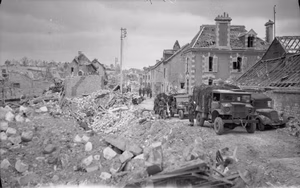 The British Army in Normandy 1944 A jeep and trucks parked in a devastated street in Caen, 10 July 1944.