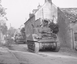 Sherman Firefly passes through Ecosville during Operation Goodwood, 18 July 1944