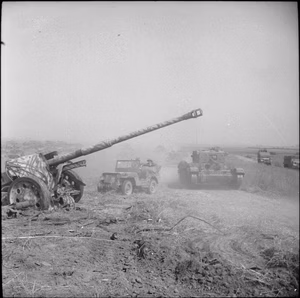 The Polish Army in the Normandy Campaign, 1944 A Cromwell tank of the 1st Polish Armoured Division and jeep pass an abandoned German 88mm anti-tank gun during Operation 'Totalise'.