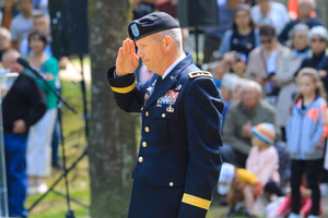 Maj. Gen. Jeffery Broadwater, the V Corps deputy commanding general, salutes after laying a wreath during a ceremony commemorating the Battle of Mortain held on “Hill 314” – the site of a remarkable defensive stand by 30th Infantry Division Soldiers 79 years ago. For five days, the DCG told an engaged local national crowd, around 700 surrounded Americans fought off assaults by the 17th Panzer Division, despite running dangerously low on ammunition and almost entirely lacking food and supplies. Despite losing 400 men during fierce fighting, the “GIs” held their crucial position until relief arrived, inflicting heavy casualties on the enemy during the process. Their courageous stand helped ensure the continued success of the U.S. breakout from Normandy in June 1944. The DCG joined town and regional officials, the USAF-E Band, support Soldiers, organizers and citizens of the small, picturesque Norman town for a captivating ceremony. Grateful local officials presented the DCG the town medal after the event. (Photo by Sgt. 1st Class Lisa Litchfield, USACAPOC)