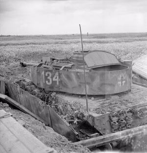 The British Army in Normandy 1944 A knocked-out German PzKpfw IV tank in a hull-down position, 13 July 1944.
