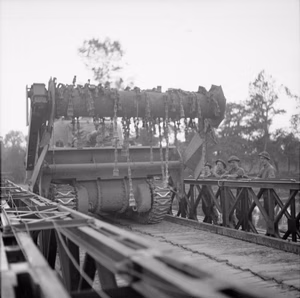 The British Army in Normandy 1944 A Sherman Crab flail tank crosses a Bailey bridge over the Orne, as it moves up to the start line for Operation 'Goodwood', 18 July 1944.
