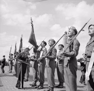 Allied Victory Parade in Brussels The Burgomaster of Brussels presents colours to the Guards Armoured Division during the victory parade.