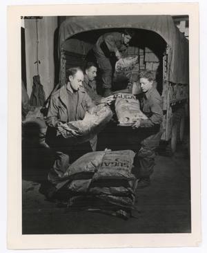 Left to right: Private First Class Stanley Barhok (Astobula, Ohio); Staff Sergeant Mivhael Kollin (715 E. 99th St., Cleveland, Ohio); Private First Class James M. McGoldrick (West Plains, MS); and Pfc. Norman Dwelle (209 4th Ave. SW Jamestown, ND). HQ Co., 3rd Battalion, 194th Glider Infantry, 17th Airborne Division, First Allied Airborne Army. Photographer: Tec 4 C.M. Pletcher.