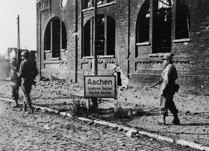 Soldiers of the 504th Parachute Infantry Regiment move through Aachen , Germany. Aachen was the first large German city to be taken by the Allies.