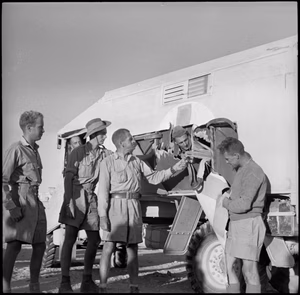 Ambulance damaged by a shell the during breakout at Minqar Qaim, June 1942. Photograph taken by Harold Paton, an official photographer of the 2nd New Zealand Expeditionary Force Shell hole in side of American Field Service ambulance in withdrawal from Minqar Qaim, Egypt - Photograph taken by H Paton. New Zealand. Department of Internal Affairs. War History Branch :Photographs relating to World War 1914-1918, World War 1939-1945, occupation of Japan, Korean War, and Malayan Emergency. Ref: DA-02550-F. Alexander Turnbull Library, Wellington, New Zealand.