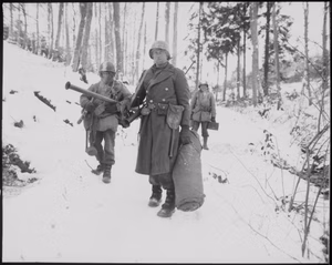 After holding a woodland position all night near Wiltz, Luxembourg, against German counter attack, three men of B Company, 101st Engineers, emerge for a rest. NARA 531349.gif