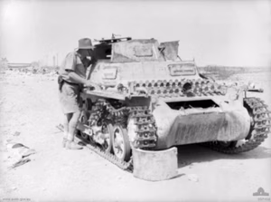 Australian Col. F.A. Burrows (2/13th) examining a German Panzer I at Tobruk on 30 April 1941. This tank was put out of action by rifle fire as it approached the outer defences of Tobruk on a reconnaissance.