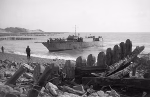 An infantry landing craft (LCI) approaching the shore to take off wounded from Walcheren, Holland, November 1944. The occupation of Walcheren Island is going fast. Flushing is in the hands of the British and troops fanning out to the West are close to the Marine Commandos coming down from the Westkapelle beachhead (where these pictures were taken). This image shows a ship coming ashore at Walcheren to take off the wounded.