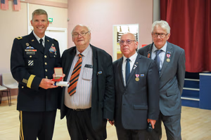 Maj. Gen. Jeffery Broadwater, the V Corps deputy commanding general, receives the town medal from local officials in Mortain, France June 3 following a ceremony commemorating the Battle of Mortain. An enthusiastic crowd of U.S. support Soldiers and townspeople joined the DCG, state and regional officials, and event organizers for a reception following a poignant ceremony punctuated by speeches, wreath-laying and patriotic music conducted on “Hill 314,” site of a heroic stand by 30th Infantry Division Soldiers in June 1944. The DCG delivered well-received featured remarks during a powerful ceremony. (Photo by Sgt. 1st Class Lisa Litchfield, USACAPOC)