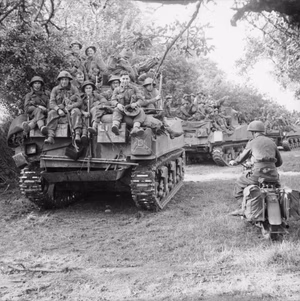 Sherman tanks of the Staffordshire Yeomanry, 27th Armoured Brigade, carrying infantry from 3rd Division, move up at the start of Operation 'Goodwood', Normandy, 18 July 1944. Sherman tanks of the Staffordshire Yeomanry, 27th Armoured Brigade, carrying infantry from 3rd Division, move up at the start of Operation 'Goodwood', 18 July 1944.