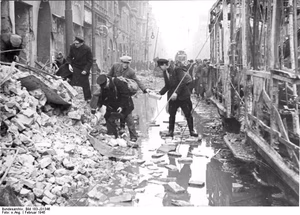 For documentary purposes the German Federal Archive often retained the original image captions , which may be erroneous, biased, obsolete or politically extreme . Berlin, Zerstörungen in der Oranienstraße Scherl: ADN-ZB/Archiv II. Weltkrieg 1939-45 Berlin nach dem Luftangriff am 3.2.1945. Ein Wasserrohr barst beim Angriff. Die Wassermassen überschwemmten die Oranienstraße. Passanten bauen aus Trümmersteinen neben einer zerstörten Straßenbahn einen Notsteg.