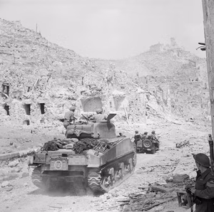 A British Sherman tank and jeep of 4th Armoured Brigade entering the ruins of Cassino, Italy, 18 May 1944. A Sherman tank and jeep of the 4th Brigade entering the ruins of Cassino. The monastery of Cassino had formed the focal point of the German Gustav Line which they had successfully defended since November 1943. The fourth offensive led by Polish and British troops secured Cassino for the Allies and caused the Germans to retreat north of Rome, which was then declared an 'open city'.