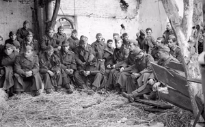 German POWs captured during the Allied assault on Walcheren Island in Holland, November 1944. The occupation of Walcheren Island is going fast. Flushing is in the hands of the British and troops fanning out to the West are close to the Marine Commandos coming downfrom the Weskapelle beachhead (where these pictures were taken). This image shows German prisoners that were taken in the fighting being housed in a barn on the way to the Prisoner of War cages.