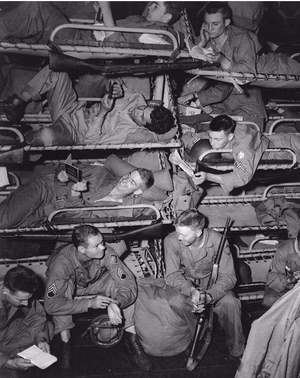 Troops en route to Oran, Algeria, 15 June 1943 Troops headed for the invasion of Sicily studying guidebooks for North Africa and otherwise passing the time in their bunks on board a U. S. Navy transport. The ship may be USS James O'Hara (APA-90). Note that these men are armed with bolt-action Springfield rifles. They are from the 45th Infantry Division. Official U.S. Navy Photograph, now in the collections of the National Archives.