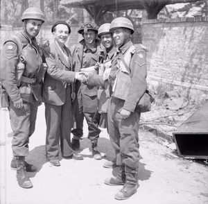 D-day - British Forces during the Invasion of Normandy 6 June 1944 A French civilian greets British troops in La Brèche d'Hermanville, 6 June 1944. The three CMP (Corps of Military Police) despatch riders are from No. 5 or 6 Beach Group (note formation sign of a red anchor on a pale blue background), attached to 3rd Division.