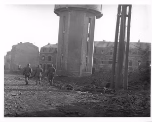 Scope and content: Original caption: Members of the 101st Airborne Division walk past dead comrades, killed during the Christmas Eve bombing of Bastogne, Belgium, the town in which this division was besieged for ten days. This photo was taken on Christmas Day. 1944