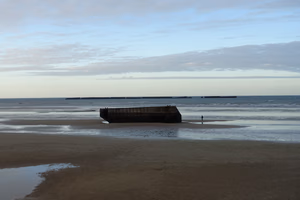 Beach with leftovers of the artificial harbour in Arromanche-les-Bains, Normandy