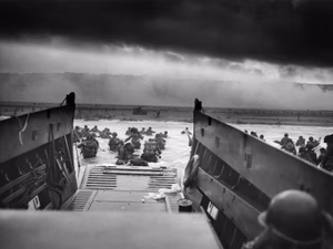A LCVP (Landing Craft, Vehicle, Personnel) from the U.S. Coast Guard -manned USS Samuel Chase disembarks troops of Company A, 16th Infantry , 1st Infantry Division (the Big Red One) wading onto the Fox Green section of Omaha Beach (Calvados, Basse-Normandie, France) on the morning of June 6, 1944. American soldiers encountered the newly formed German 352nd Division when landing. During the initial landing two-thirds of Company E became casualties.