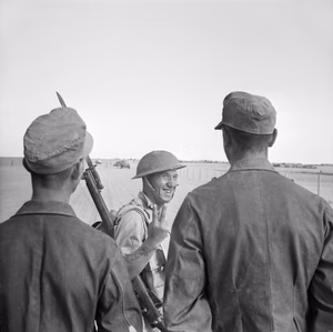 A British soldier gives the "insult" version of a V-for-Victory sign to German prisoners captured at El Alamein, 26 October 1942. A British soldier gives a V-for-Victory sign to German prisoners captured at El Alamein, 26 October 1942.