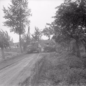 Operation 'market Garden' - the Battle For Arnhem, September 1944 A Sherman tank of the 4th/7th Dragoon Guards passes a German PzKpfw III German PzKpfw III tank of Panzer-Kompanie Mielke, Kampfgruppe Knaust (knocked out previously by No. 1 Squadron, Welsh Guards), in Oosterhout near Nijmegen, 24 September 1944.