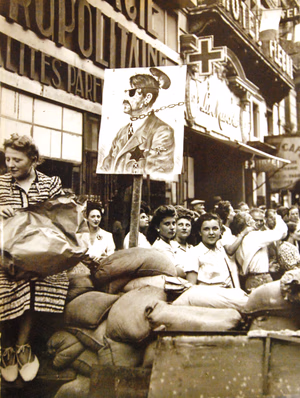 Lot 4568-5: Liberation of Paris, France, August 25, 1944. Barricades go up in the city, note the transformed portrait.Photographed through Mylar sleeve. (7/10/2015).