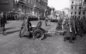 The soldiers on the foreground are moving a Hungarian 40 mm MAWAG anti-tank gun M1940 (designated as 40.M or 40M). The King Tiger on the backround is of Schwere Panzer-Abteilung 503, an only Tiger II unit to go to Budapest [ 1 ]