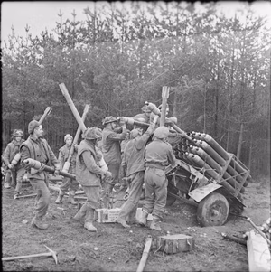British troops loading rocket projectiles in preparation for the offensive in the Reichswald , Germany.
