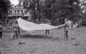 The British Army in North-west Europe 1944-45 1st Airborne soldiers use parachutes to signal to Allied supply aircraft from the grounds of 1st Airborne Division's HQ at the Hartenstein Hotel in Oosterbeek, Arnhem, 23 September 1944.