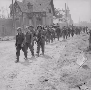 D-day - British Forces during the Invasion of Normandy 6 June 1944 German prisoners being escorted back through La Brèche d'Hermanville by men of the 2nd King's Shropshire Light Infantry, 6 June 1944.
