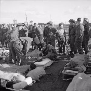The British Army in North-west Europe 1944-45 Wounded at Breskens await transport to hospital after being evacuated from Flushing during the assault on Walcheren, 2 November 1944.