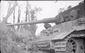 The British Army in Normandy 1944 A soldier of 10th Durham Light Infantry digs in close to a knocked-out German Tiger tank at Rauray, 28 June 1944.