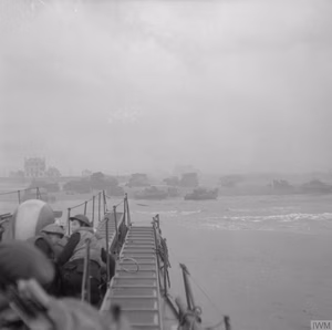 D-day - British Forces during the Invasion of Normandy 6 June 1944 Commandos of 1st Special Service Brigade approach Queen Red beach, Sword area, c. 0840 hours, 6 June 1944. Sherman DD tanks of 13th/18th Royal Hussars and the specialised armour of 79th Armoured Division can be seen crowding together on the beach ahead.