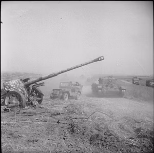 The British Army in the Normandy Campaign 1944 A Cromwell tank and jeep pass an abandoned German 88mm anti-tank gun during Operation 'Totalise', 8 August 1944.
