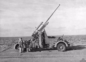 An abandoned German 88 mm Flak 36 or 37 gun in North Africa.