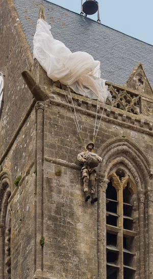 US Paratrooper, representing John Steele (paratrooper) , 82nd Airborne, june 6th, 1944, bell tower of church of Sainte-Mère-Église, Manche, Normandy, France.