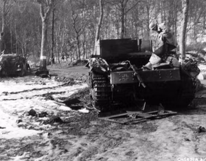 A destroyed German Bergepanzer III recovery vehicle and another tank (Sturmgeschütz II?) near Hosingen, Luxembourg, in February 1945.