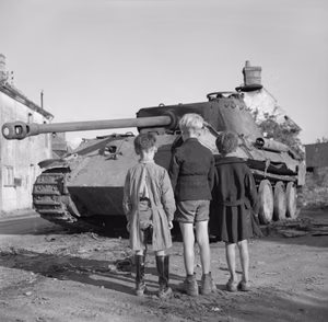 Three French boys looking at a knocked-out German Panther tank in the Falaise pocket, Normandy, 25 August 1944. Three French boys looking at a knocked-out German Panther tank in the Falaise pocket, 25 August 1944.