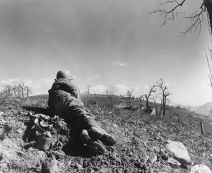 The Germans had refused to surrender to troops occupying this knoll about 150-200 yards away. 3 March, 1945. Company K, 87th Infantry Regiment, 10th Mountain Division. Photographer: Baker, 196th Signal Photo Co.
