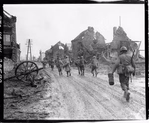 American infantrymen move through Hurtgen, Germany, on their way to the front lines. Company I, 181st Regiment, 8th Infantry Division.