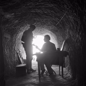 The commanding officer of an armoured unit receives a message at his HQ located in a tunnel within the Tobruk perimeter, 12 September 1941. The commanding officer of an armoured unit receives a message at his HQ located in a tunnel within the Tobruk perimeter, 12 September 1941.