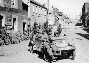 U.S. Airborne paratroopers in and on a captured VW Kübelwagen and by houses in Carentan, en:Battle of Normandy , 1944.