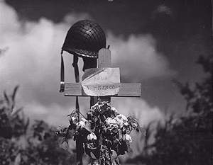 "French civilians erected this silent tribute to an American soldier who has fallen in the crusade to liberate France from German domination. Carentan , France, 06/17/1944".