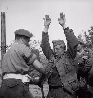 Canadian troops searching German prisoners captured during the early stages of Operation Totalize, Tilly-la-Campagne, France (vicinity) Source: Library and Archives Canada USE/REPRODUCTION: Restrictions on use/reproduction: Nil Copyright: Expired Credit: Harold G. Aikman / Canada. Dept. of National Defence / Library and Archives Canada / PA-162000