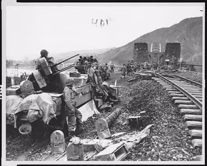 Ludendorff bridge at Remagen after its capture on March 7, 1945, showing U.S. 1st Army troops crossing the Rhine into Germany. Failure of the Germans to destroy the bridge gave U.S. forces their first foothold east of the Rhine — Bridges--Germany (West)--Remagen--1940-1950. World War, 1939-1945--Campaigns & battles--Germany (West)--Remagen. Troop movements--American--Germany (West)--Remagen--1940-1950. Photographic prints--1940-1950. — 1945.