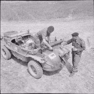 The British Army in Normandy 1944 Men of 23rd Hussars, 11th Armoured Division, painting divisional and arm of service markings on a German Schwimmwagen captured from 12th SS Panzer Division (HitlerJugend), 6 July 1944.