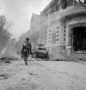 The British Army in North-west Europe 1944-45 A scout car and infantry fighting their way through Arnhem, 14 April 1945.